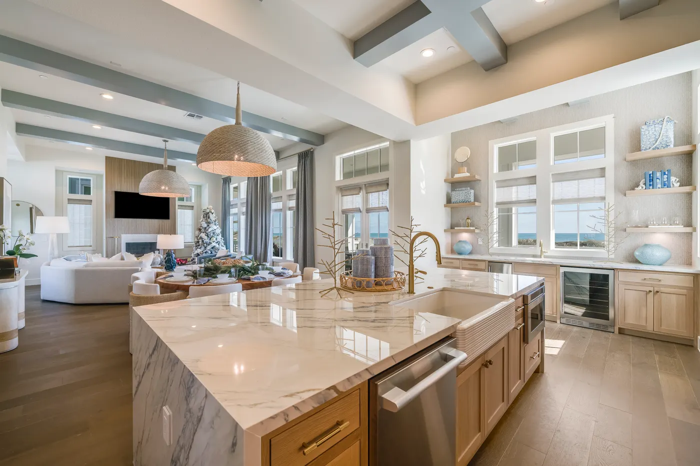 Island kitchen under vaulted beams in a coastal home