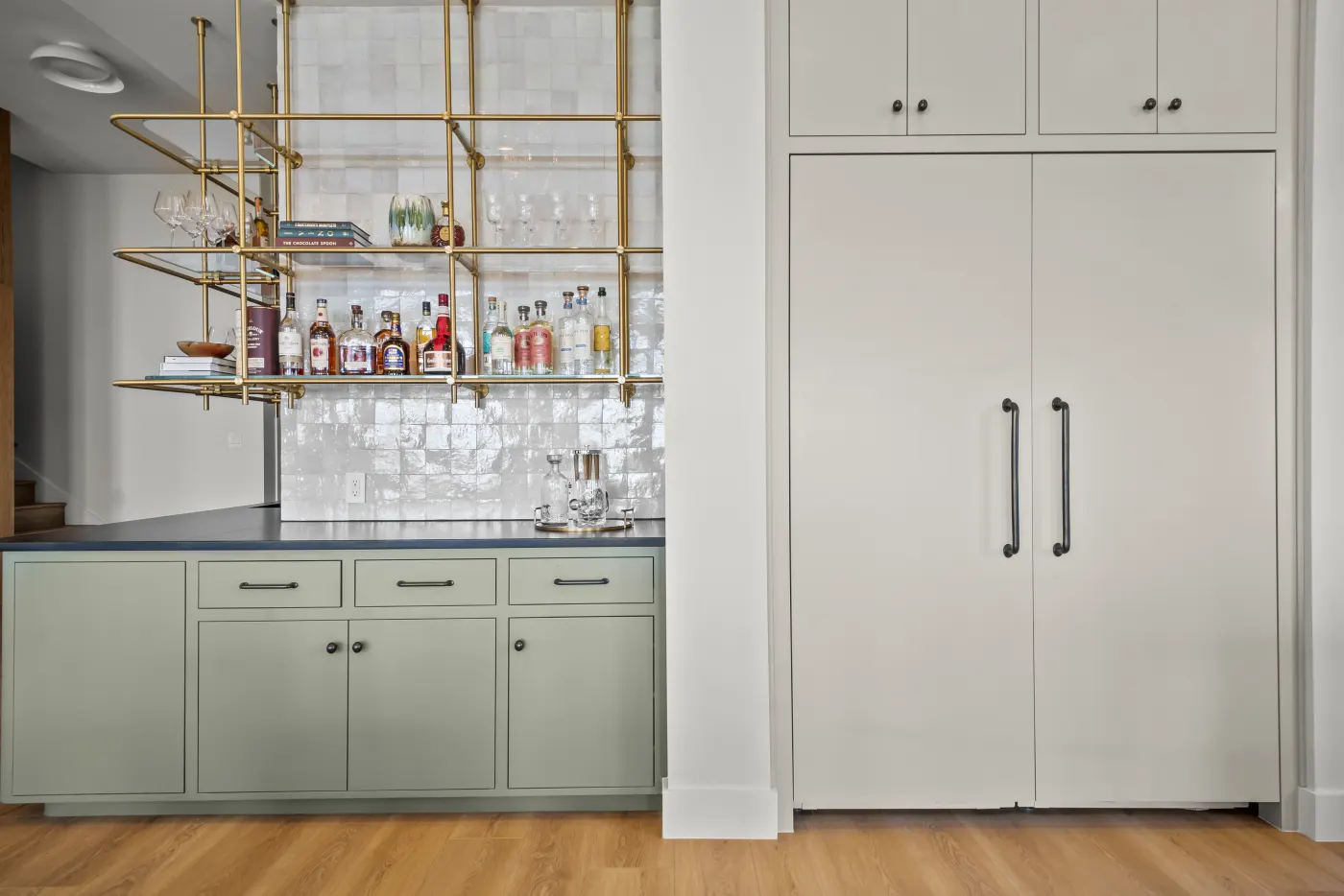 A custom bar in sage green and brass